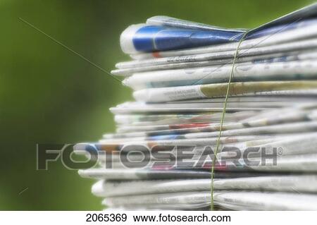 Stock Photo - Newspapers Tied Into A Pile For The Recycle Bin.. Fotosearch