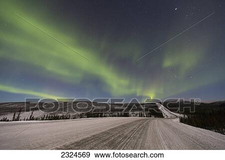 Stock Photo - Northern lights dancing over the james dalton highway in winter north of fairbanks; Alaska united states of america. Fotosearch