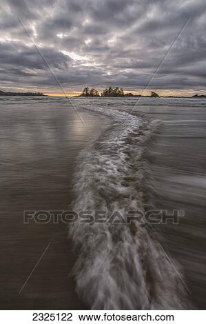 Stock Image - Opposing waves strike each other on chesterman beach; Tofino british columbia canada. Fotosearch