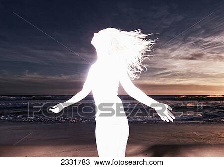 Stock Image - Overexposure of a female teenager's figure on a beach; Tarifa cadiz andalusia spain. Fotosearch