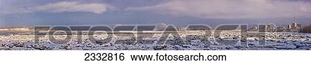 Stock Photograph - Panorama photo of the Downtown Anchorage Skyline as seen from the Tony Knowles Coastal Trail, Frozen Knik Arm in the foreground, Winter, Anchorage, Southcentral Alaska, USA.. Fotosearch
