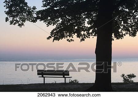 Stock Image - Park And Bench On The Shores Of Lake Ontario - Niagara-On-The-Lake - Ontario, Canada. Fotosearch