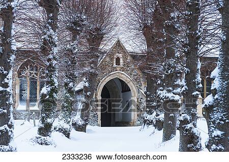 Stock Photograph - Path leading to a church in the snow; Great wilbraham cambridgeshire england. Fotosearch
