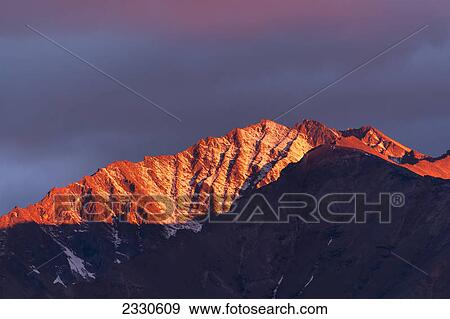 Stock Photo - Peaks in the brooks range glowing at sunset near the noatak river; Alaska united states of america. Fotosearch