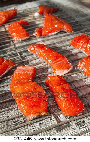 Pieces of kenai river red sockeye salmon sitting on drying racks in preparation for putting them in a smoker; Anchorage alaska united states of america View Large Photo Image Stock Photograph - Pieces of kenai river red sockeye salmon sitting on drying racks in preparation for putting them in a smoker; Anchorage alaska united states of america. Fotosearch