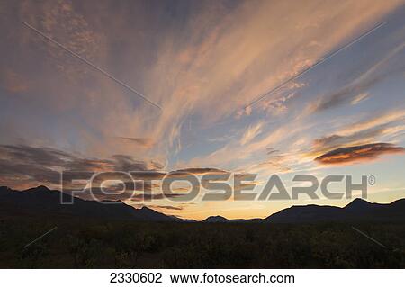Stock Image - Pink clouds above brooks range at sunset gates of the arctic national park northwestern alaska; Alaska united states of america. Fotosearch