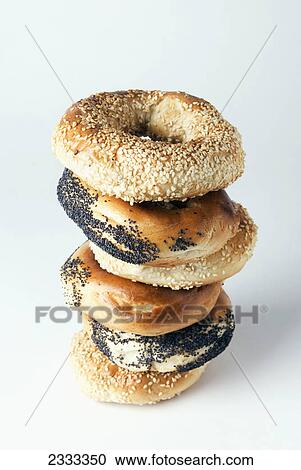 Stock Image - Poppy seed and sesame seed bagels on a white background. Fotosearch