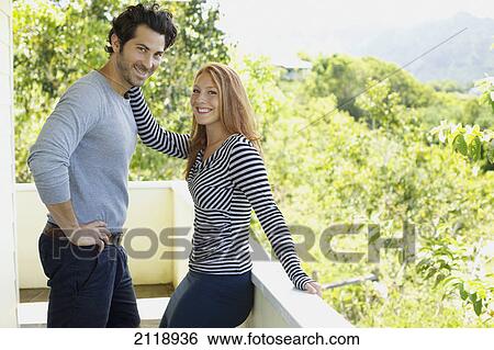 Stock Photograph - Portrait Of A Couple On A Balcony; Wailua Kauai Hawaii United States Of America. Fotosearch