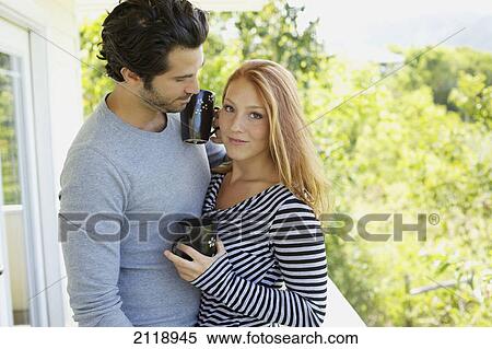 Portrait Of A Couple On A Balcony With Their Coffee Mugs; Wailua Kauai Hawaii United States Of America View Large Photo Image Stock Photography - Portrait Of A Couple On A Balcony With Their Coffee Mugs; Wailua Kauai Hawaii United States Of America. Fotosearch
