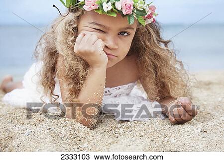 Portrait of a cute young girl laying on beach making a face; Waikiki oahu hawaii united states of america View Large Photo Image Stock Image - Portrait of a cute young girl laying on beach making a face; Waikiki oahu hawaii united states of america. Fotosearch
