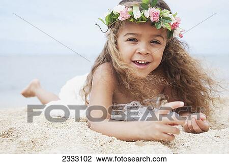 Portrait of a girl laying on the sand beach with a floral wreath around her head; Waikiki oahu hawaii united states of america View Large Photo Image Stock Image - Portrait of a girl laying on the sand beach with a floral wreath around her head; Waikiki oahu hawaii united states of america. Fotosearch