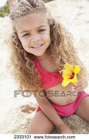 Portrait of a girl on the beach holding a hibiscus flower; Waikiki oahu hawaii united states of america View Large Photo Image Stock Image - Portrait of a girl on the beach holding a hibiscus flower; Waikiki oahu hawaii united states of america. Fotosearch