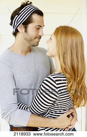 Stock Image - Portrait Of A Man And Woman In An Embrace Looking At One Another; Wailua Kauai Hawaii United States Of America. Fotosearch