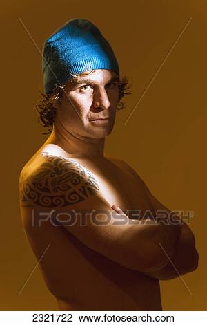 Portrait Of A Shirtless Man With A Large Tattoo On His Shoulder Wearing A Cap; Tarifa Cadiz Andalusia Spain View Large Photo Image Stock Image - Portrait Of A Shirtless Man With A Large Tattoo On His Shoulder Wearing A Cap; Tarifa Cadiz Andalusia Spain. Fotosearch