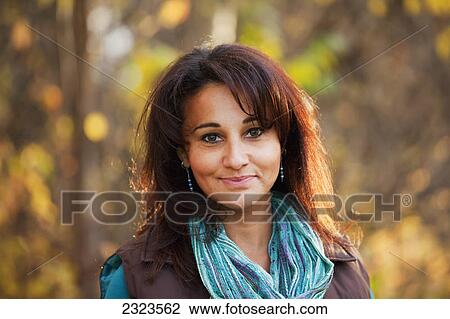 Stock Image - Portrait of a woman in a park in autumn; Edmonton alberta canada. Fotosearch
