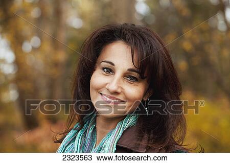 Stock Image - Portrait of a woman in a park in autumn; Edmonton alberta canada. Fotosearch