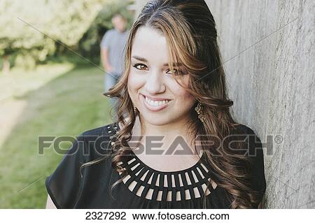 Portrait of a woman with a man in the background; White rock british columbia canada View Large Photo Image Stock Image - Portrait of a woman with a man in the background; White rock british columbia canada. Fotosearch
