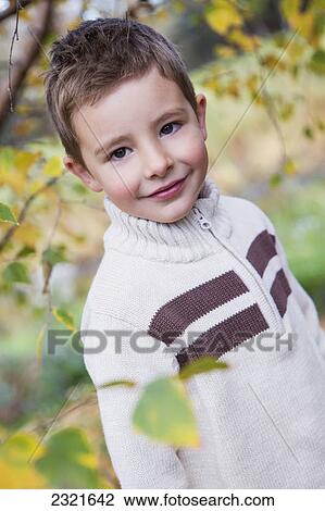 Stock Image - Portrait Of A Young Boy In Autumn; St. Albert Alberta Canada. Fotosearch