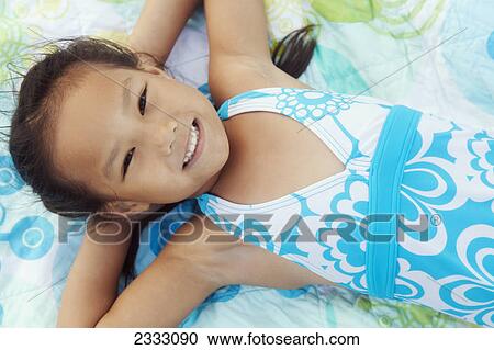 Portrait of a young girl laying on a blanket; Honolulu oahu hawaii united states of america View Large Photo Image Stock Image - Portrait of a young girl laying on a blanket; Honolulu oahu hawaii united states of america. Fotosearch