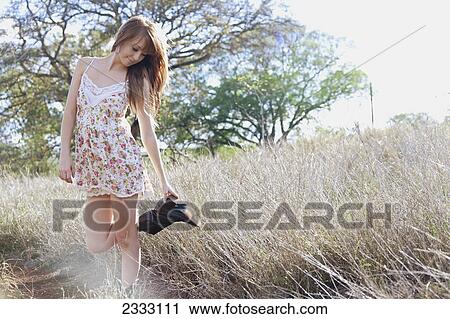 Portrait of a young woman with long hair in the long grass; Honolulu oahu hawaii united states of america View Large Photo Image Stock Image - Portrait of a young woman with long hair in the long grass; Honolulu oahu hawaii united states of america. Fotosearch