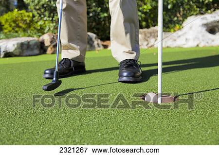 Stock Photo - Putting Into The Hole; Kissimmee Florida United States Of America. Fotosearch