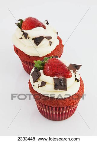Red velvet cupcakes with icing garnished with chocolate and strawberries on a white background; Hawaii united states of america View Large Photo Image Stock Photo - Red velvet cupcakes with icing garnished with chocolate and strawberries on a white background; Hawaii united states of america. Fotosearch