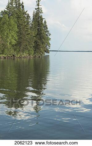 Stock Image - Reflection In Clear Lake, Riding Mountain National Park, Manitoba, Canada. Fotosearch