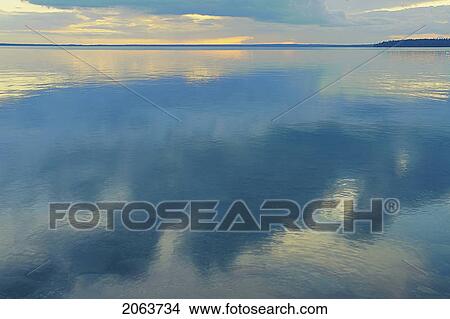 Picture - Reflection Of Clouds In Clear Lake; Canada, Manitoba, Riding Mountain National Park. Fotosearch