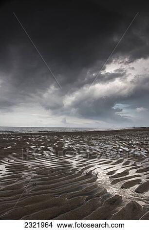 Rippled Sand Under A Dark Cloud At The Water's Edge; Northumberland England View Large Photo Image Picture - Rippled Sand Under A Dark Cloud At The Water's Edge; Northumberland England. Fotosearch