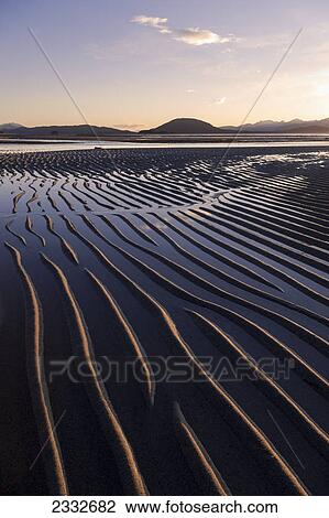 Ripples are revealed as the evening tide recedes eagle beach state recreation area near juneau; Alaska united states of america View Large Photo Image Stock Image - Ripples are revealed as the evening tide recedes eagle beach state recreation area near juneau; Alaska united states of america. Fotosearch