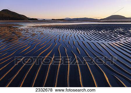 Ripples are revealed as the evening tide recedes eagle beach state recreation area near juneau; Alaska united states of america View Large Photo Image Stock Photo - Ripples are revealed as the evening tide recedes eagle beach state recreation area near juneau; Alaska united states of america. Fotosearch