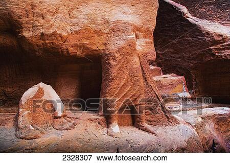 Stock Photo - Rock carved into the lower half of a human body; Petra jordan. Fotosearch