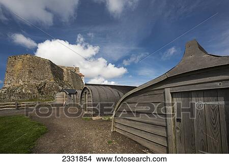 Rounded wooden buildings and a stone building on holy island; Northumberland england View Large Photo Image Picture - Rounded wooden buildings and a stone building on holy island; Northumberland england. Fotosearch