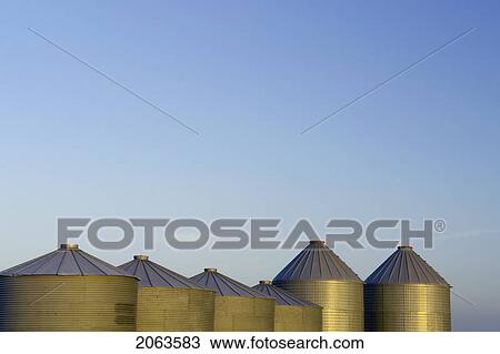 Stock Image - Row Of Metal Graneries; Canada, Manitoba, Erickson. Fotosearch