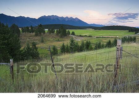 Rural Farmland And Rocky Mountains, Cranbrook, Bc, Canada View Large Photo Image Stock Photo - Rural Farmland And Rocky Mountains, Cranbrook, Bc, Canada. Fotosearch