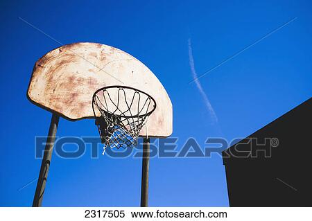 Stock Photography - Rusty Basketball Hoop Against A Blue Sky; Beloeil Quebec Canada. Fotosearch