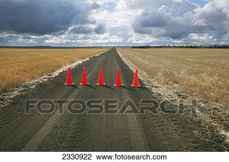 Safety cones lined up across a rural road; Saskatchewan canada View Large Photo Image Stock Image - Safety cones lined up across a rural road; Saskatchewan canada. Fotosearch