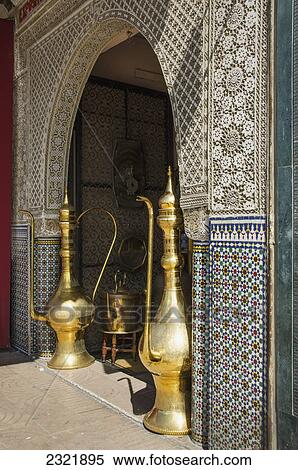 Shiny Gold Decorative Large Teapots On Display In An Archway With Patterned Facade; Casablanca Morocco View Large Photo Image Stock Photography - Shiny Gold Decorative Large Teapots On Display In An Archway With Patterned Facade; Casablanca Morocco. Fotosearch