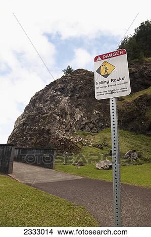 Picture - Sign at nuuanu pali lookout warns to look out for falling rocks; Oahu hawaii united states of america. Fotosearch