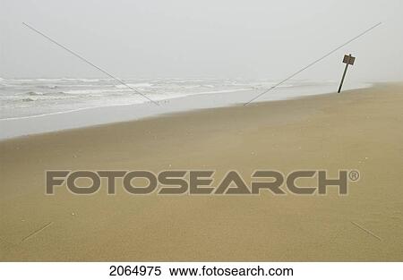 Stock Photography - Sign On Flat Sandy Beach With Mist In The Background, Reedsport, Oregon. Fotosearch