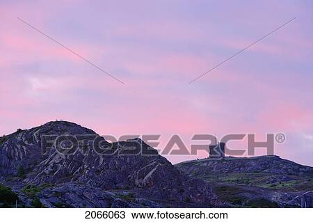 Stock Image - Signal Hill National Historic Site. View Of Cabot Tower At Dawn, St. John's, Newfoundland, Canada. Fotosearch