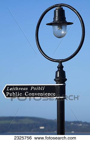 Stock Photograph - Signpost with light against a blue sky; Duncannon county wexford ireland. Fotosearch