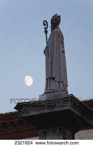 Picture - Silhouetted Statue Of A Bishop With The Moon In The Sky; Ravenna Emilia-Romagna Italy. Fotosearch