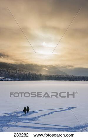 Sillhouetted ice fisherman on Summit Lake, clouds clearing from the Kenai Mountains behind the lake, Chugach National Forest, Backlit sun, Winter, Southcentral Alaska, USA. View Large Photo Image Stock Image - Sillhouetted ice fisherman on Summit Lake, clouds clearing from the Kenai Mountains behind the lake, Chugach National Forest, Backlit sun, Winter, Southcentral Alaska, USA.. Fotosearch