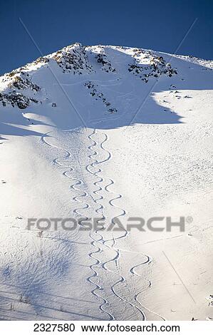 Snow covered mountain peak with skier tracks and deep blue sky; Lake louise alberta canada View Large Photo Image Stock Image - Snow covered mountain peak with skier tracks and deep blue sky; Lake louise alberta canada. Fotosearch