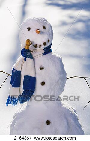Stock Photo - Snowman In The Woods In Afternoon Light After Making Snow Angel Interior Alaska Winter. Fotosearch