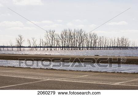 Stock Photo - Spring Floodwater Of Red River Come Close To Covering Highway. Fotosearch