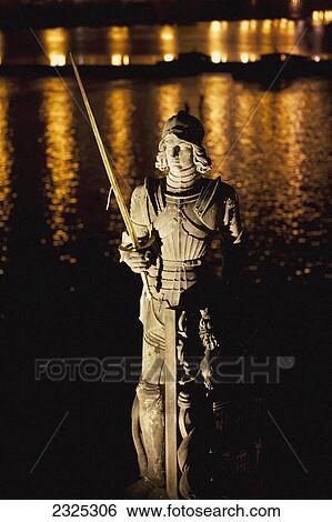 Statue illuminated by light with light reflecting on the water in the background; Prague czech republic View Large Photo Image Stock Photograph - Statue illuminated by light with light reflecting on the water in the background; Prague czech republic. Fotosearch