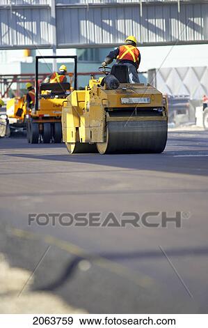 Stock Photo - Steam Rollers Paving New Asphalt; Canada, Ontario, Hamilton (Composting Facility). Fotosearch