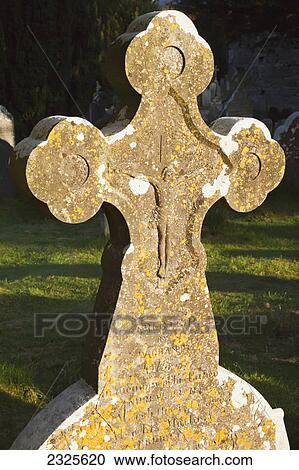 Stock Image - Stone tombstone in the shape of a cross; Glendalough county wicklow ireland. Fotosearch